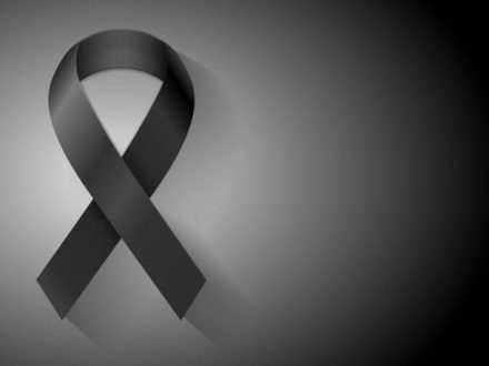 Mourning ribbon on a black background. Vector illustration.