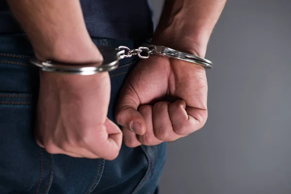 depositphotos_169815564-stock-photo-man-with-his-hands-handcuffed