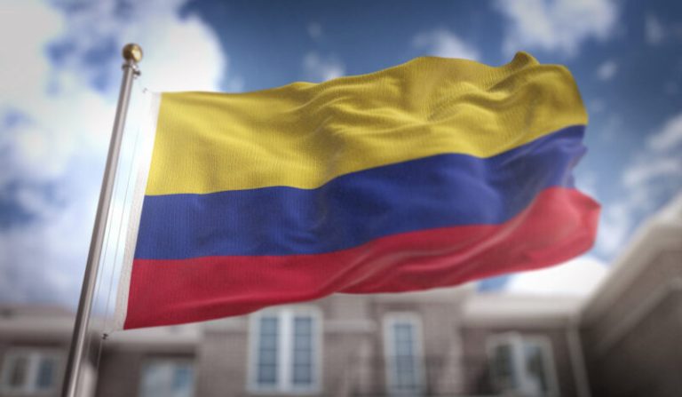 colombia-flag-3d-rendering-blue-sky-building-background-e1652410785916